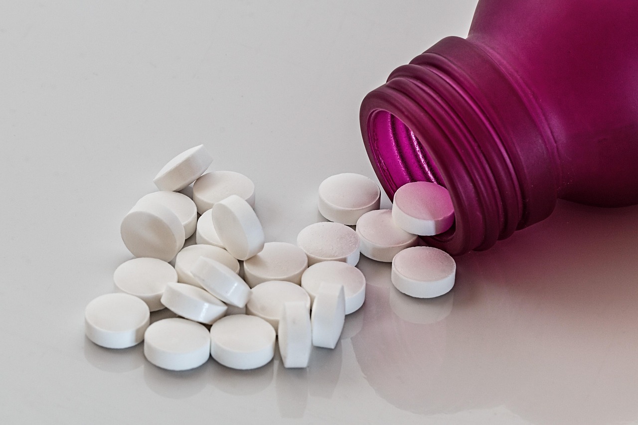 Pharmacist organizing prescription medication bottles on a shelf