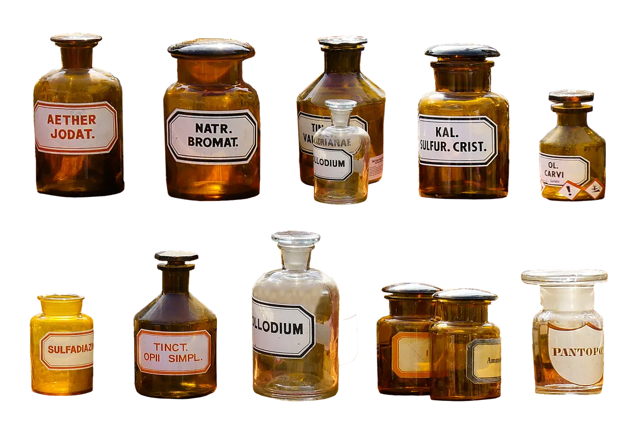 Glass vials and bottles of pharmaceutical liquid lined up in a lab