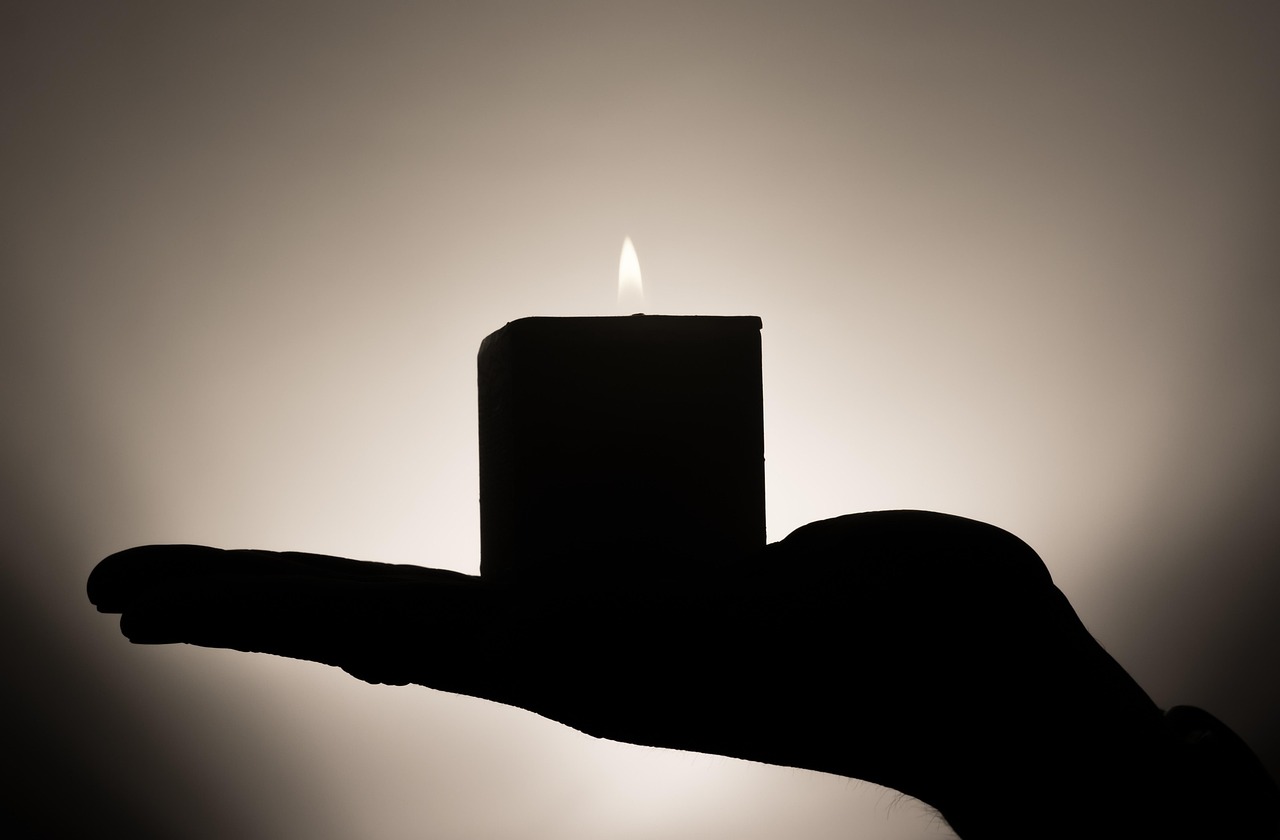 Candle, hand, candlelight — illustrating Autoregulation: Adjusting Training Load to How You Actually Feel