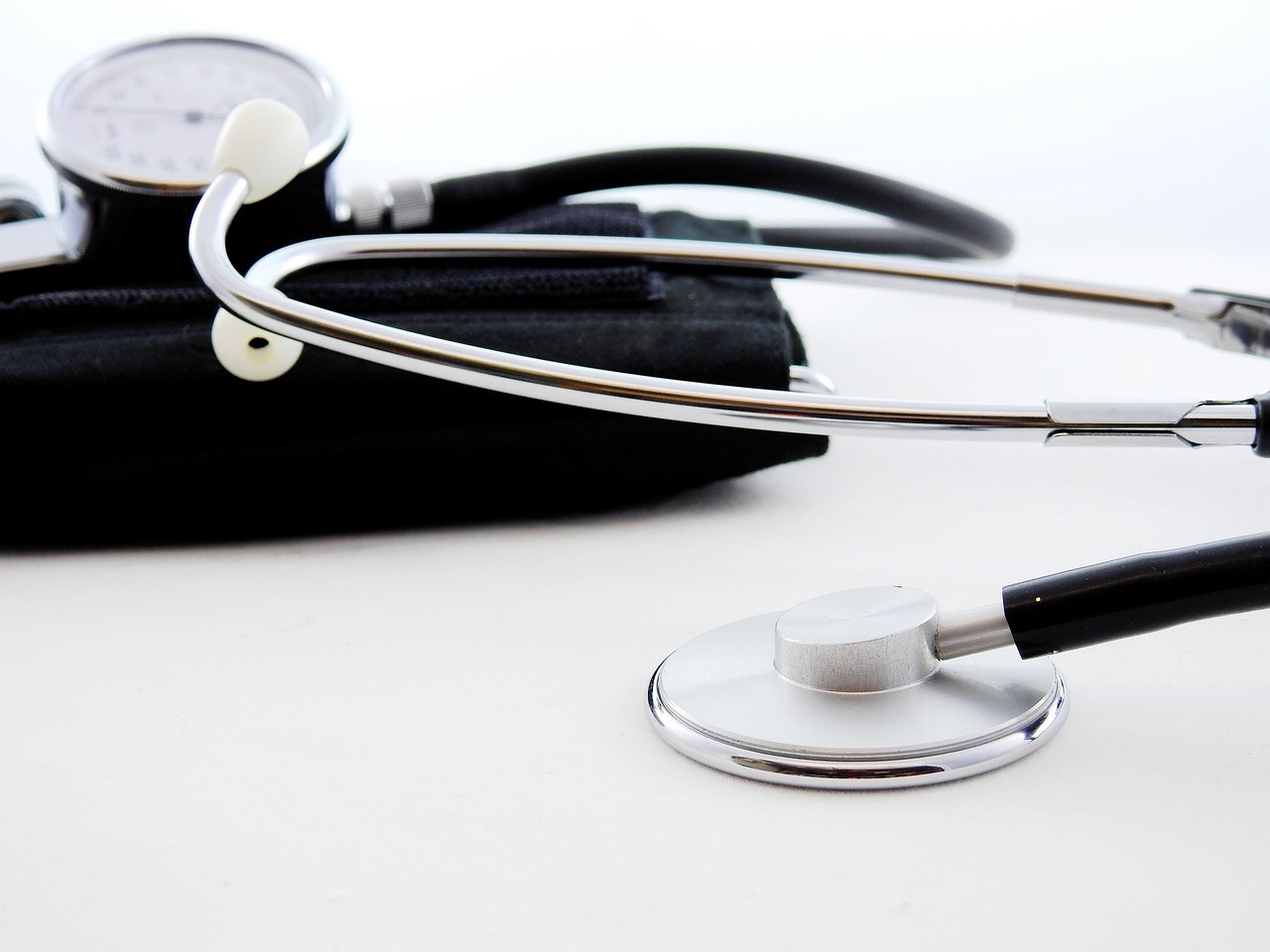 Doctor using a stethoscope alongside a blood pressure monitor, representing the well-validated, boring-but-effective clinical markers worth tracking