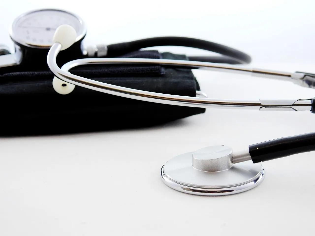 Doctor using a stethoscope alongside a blood pressure monitor, representing the well-validated, boring-but-effective clinical markers worth tracking