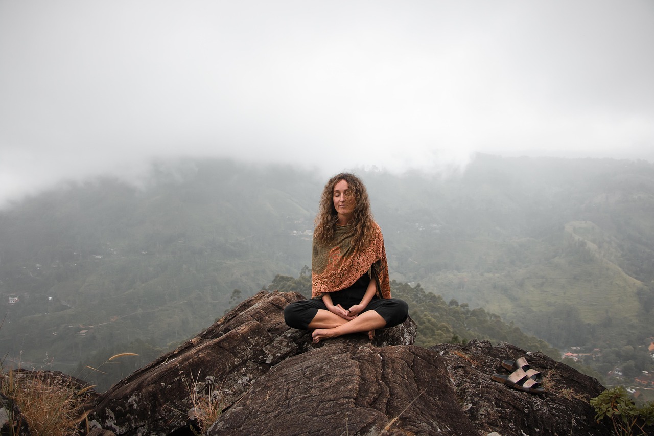 Person meditating outdoors in a peaceful natural setting, illustrating a calm parasympathetic state