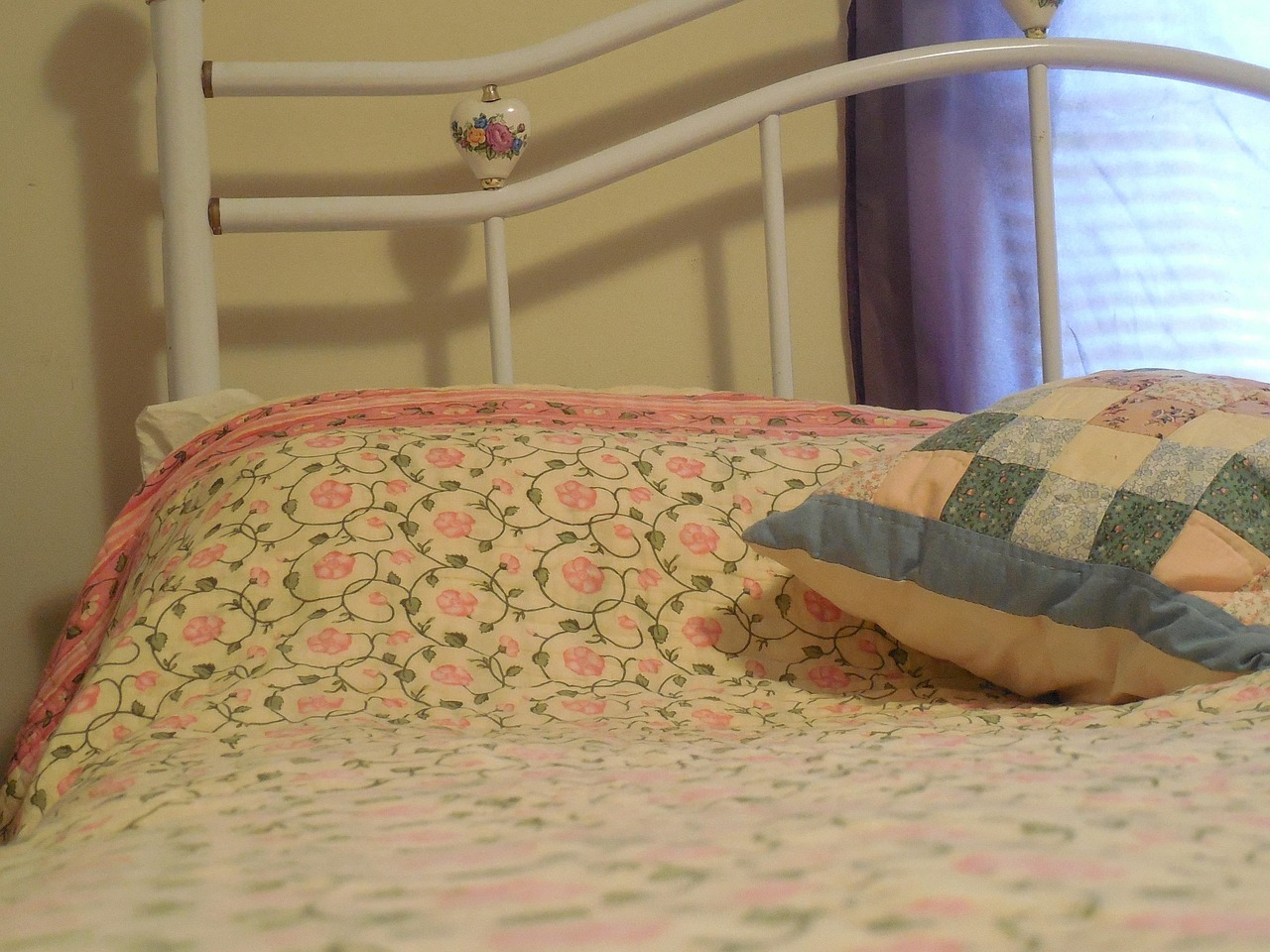 A neatly made bed with white pillows and linens, evoking the uninterrupted rest that good caffeine timing protects