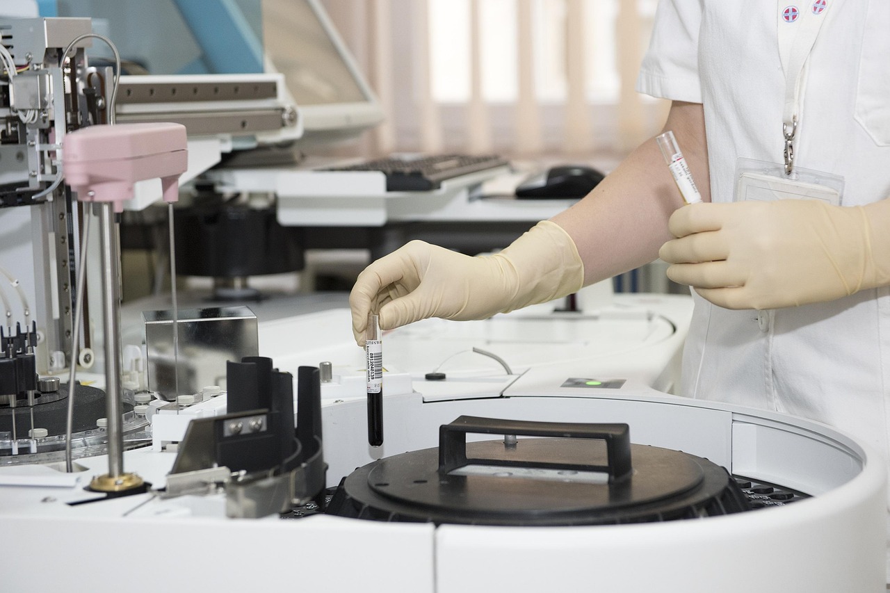 Scientist in a lab coat examining a sample in a research laboratory, representing the testing and verification standards compounded drugs skip