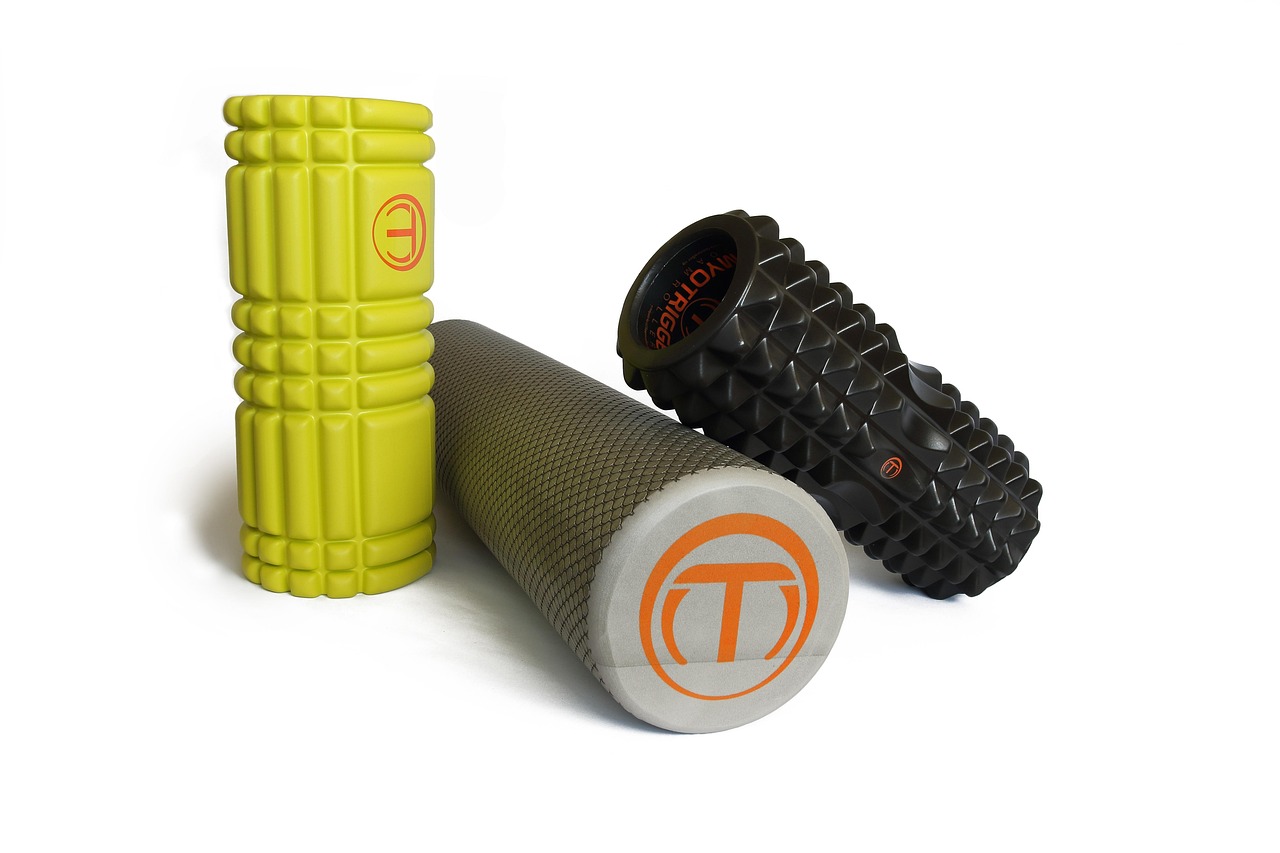 Close-up of a person using a textured foam roller on their leg muscles during a recovery session