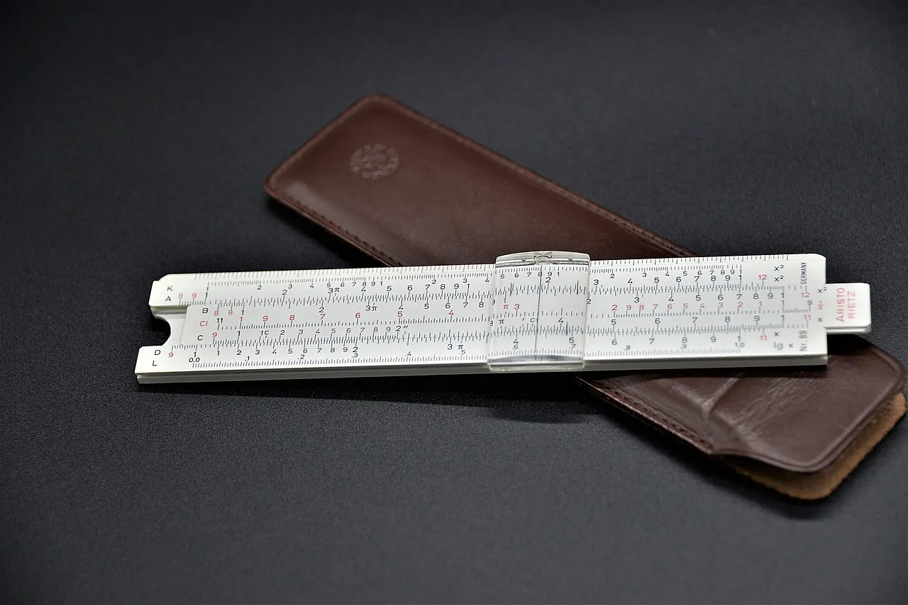 Slide rule, computing device, logarithmic — illustrating How Long Semaglutide and Tirzepatide Stay in Your System After the Last Dose