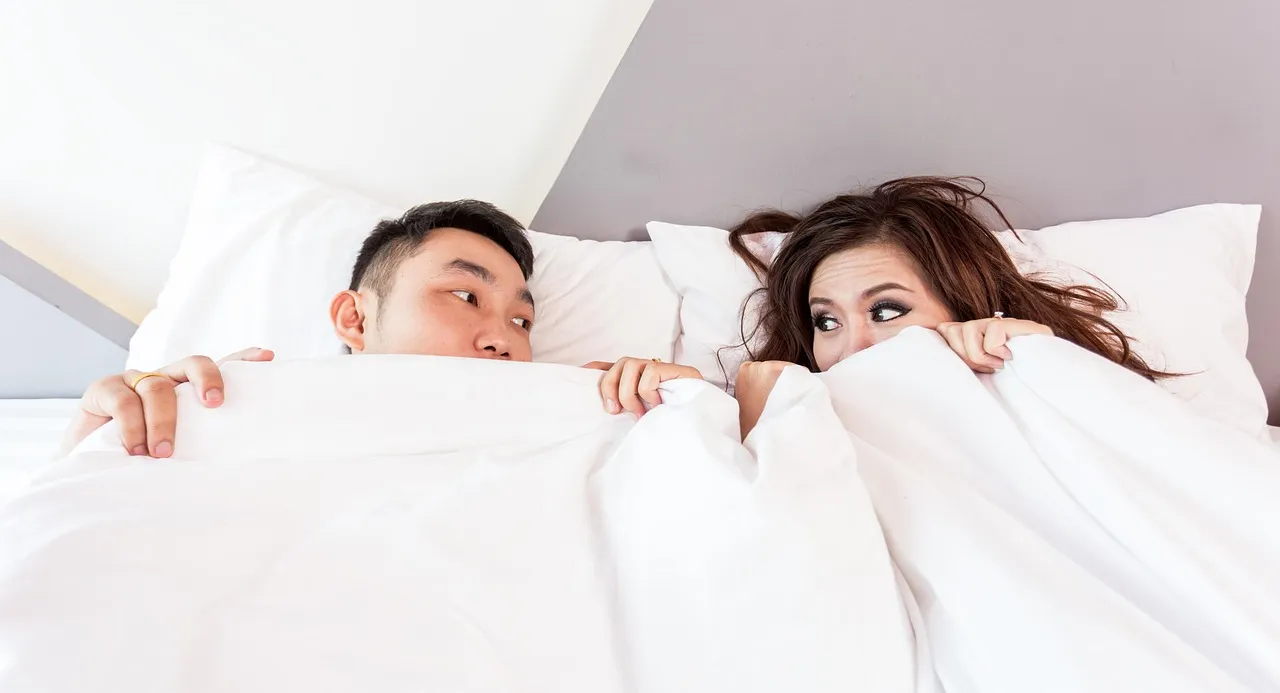 Happy valentines day, couple, lying — illustrating Sleep and Hormones: Testosterone, Cortisol, GH