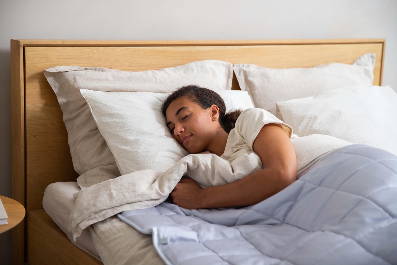 Woman, bed, blanket — illustrating Sleep and Muscle Recovery: What the Evidence Shows