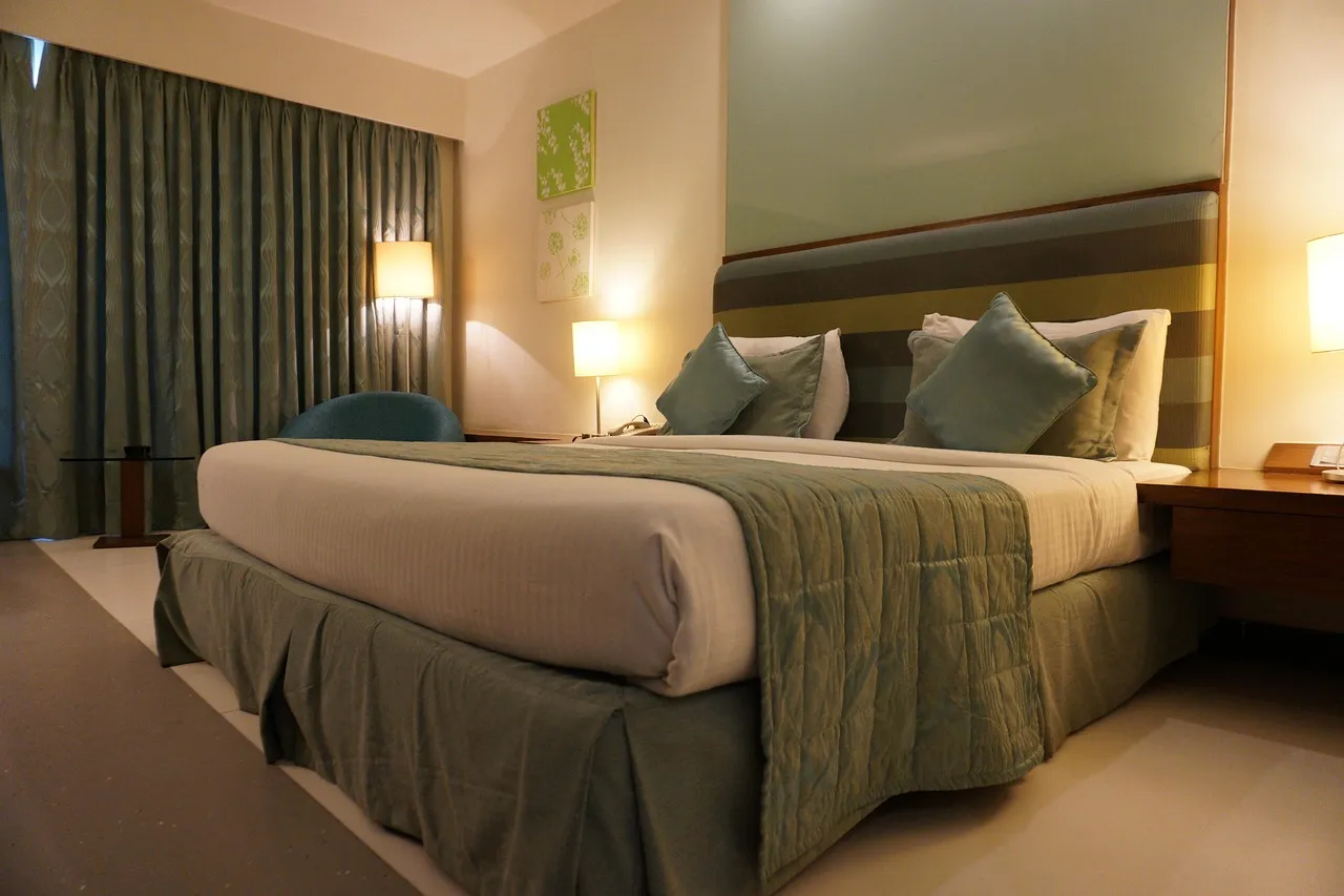 Hotel, room, bed — illustrating Sleep and Muscle Recovery: What the Evidence Shows