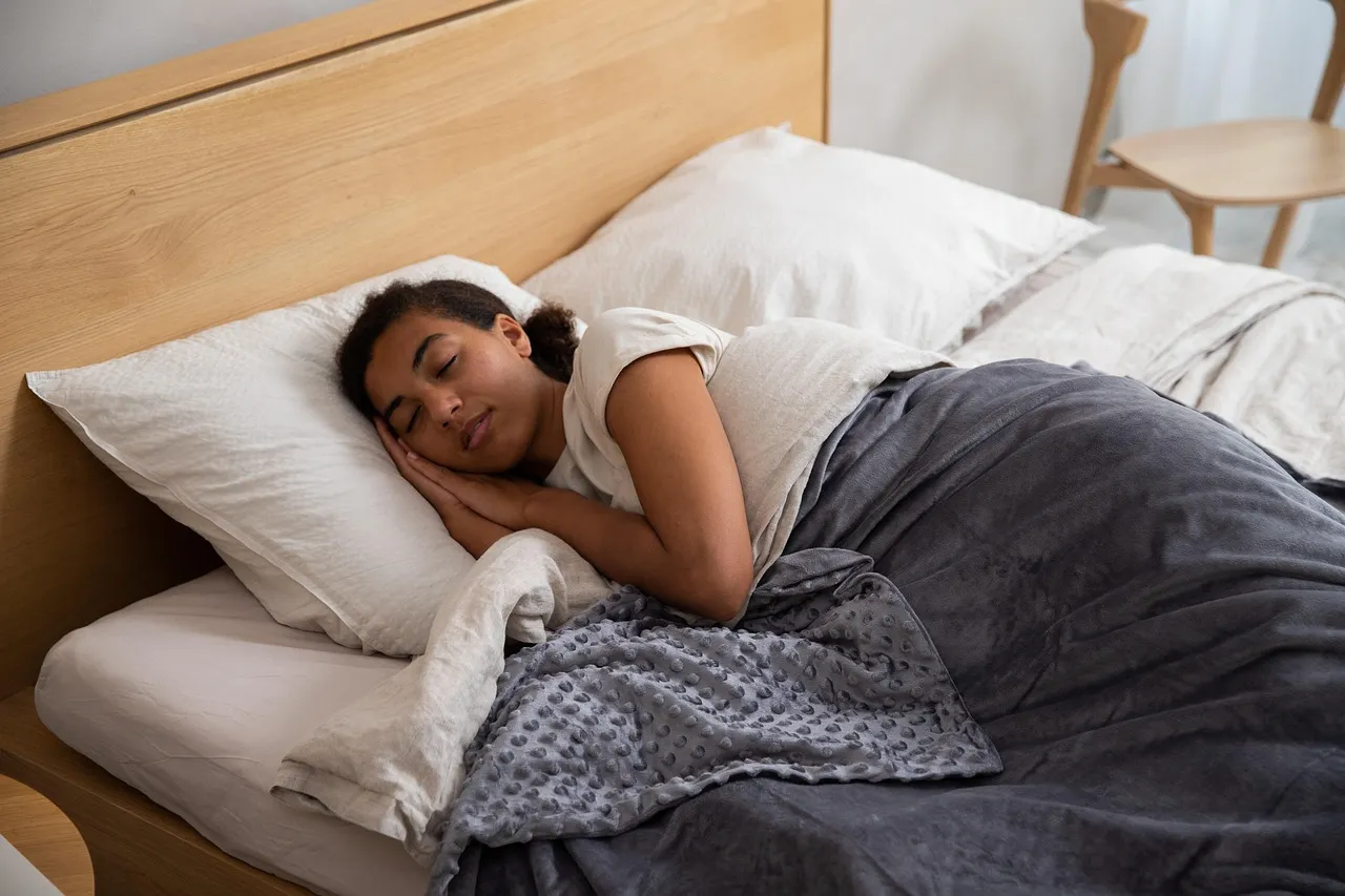 Woman, bed, blanket — illustrating Sleep Trackers: How Accurate Are They?