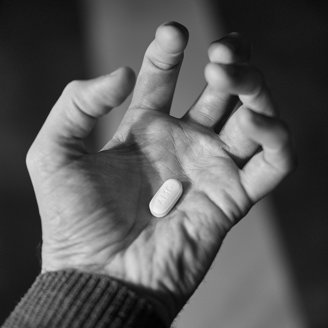 Hand, pill, pills — illustrating Urolithin A and Mitophagy