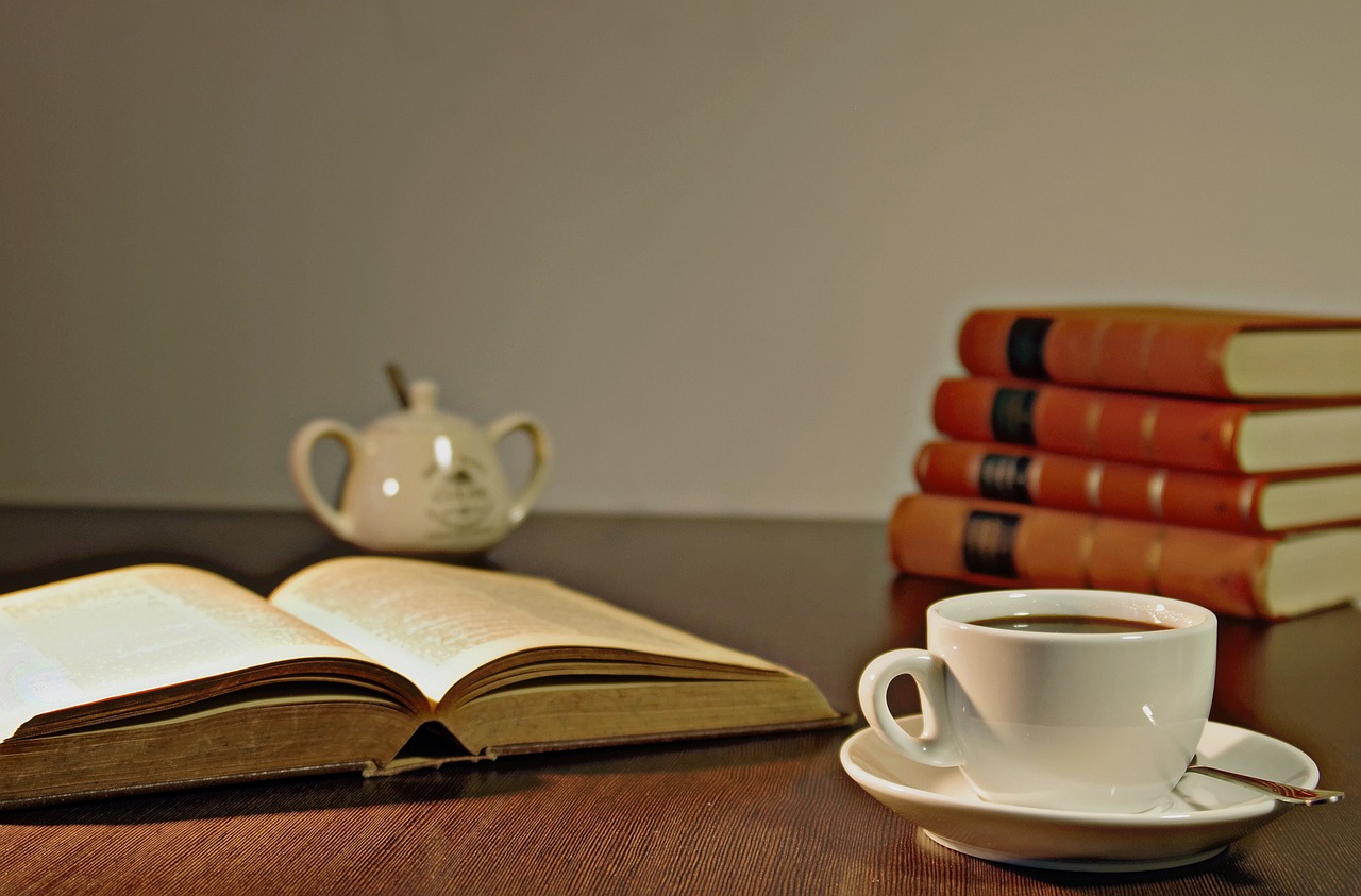 Coffee, books, reading — illustrating When to Take a Deload Week: Signs You Need One and How to Structure It